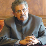 the newly appointed minister for overseas indian affairs shri vayalar ravi pose for lensmen after assuming the charge of his office, in new delhi on january 30,2006