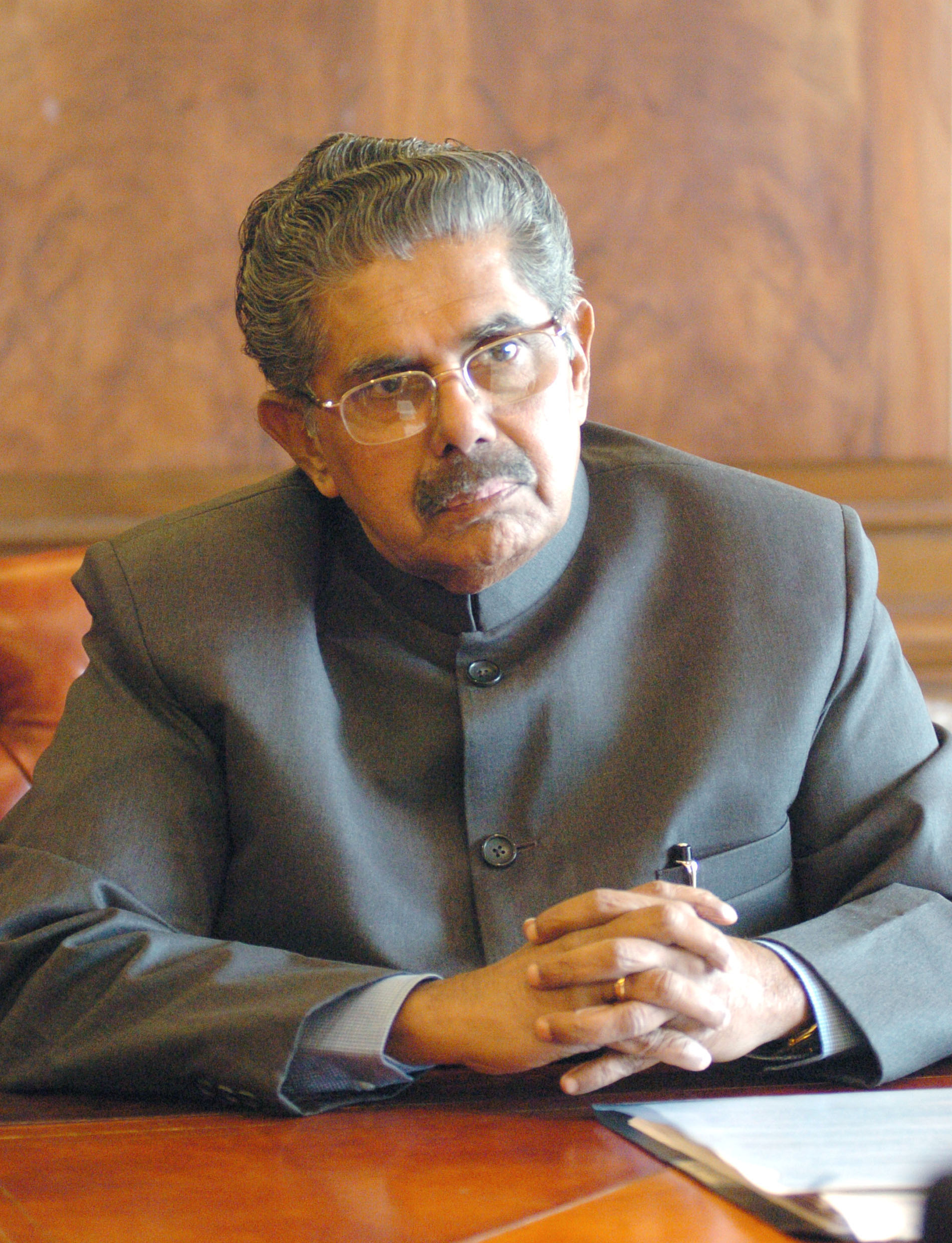 the newly appointed minister for overseas indian affairs shri vayalar ravi pose for lensmen after assuming the charge of his office, in new delhi on january 30,2006